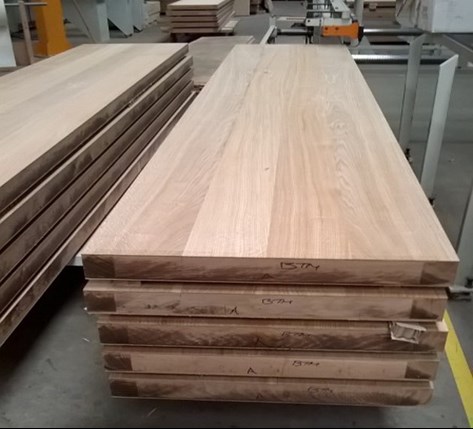 Stack of doors with constructional veneer flitches pressed to faces